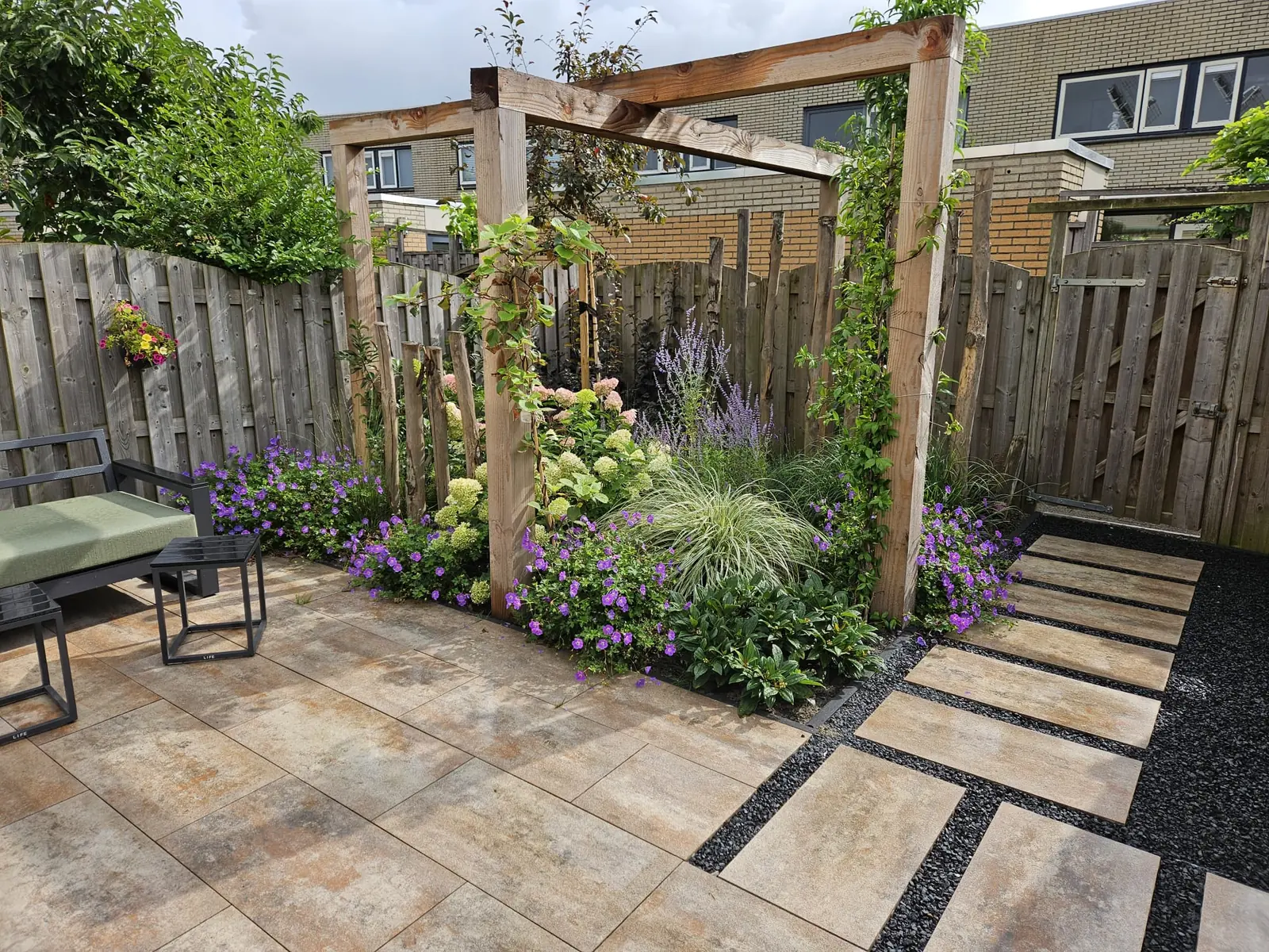 Tuin met pergola, terras en stapstenen in grind